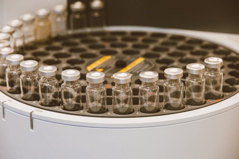 Glass peptide vials with rubber stoppers in a laboratory rack
